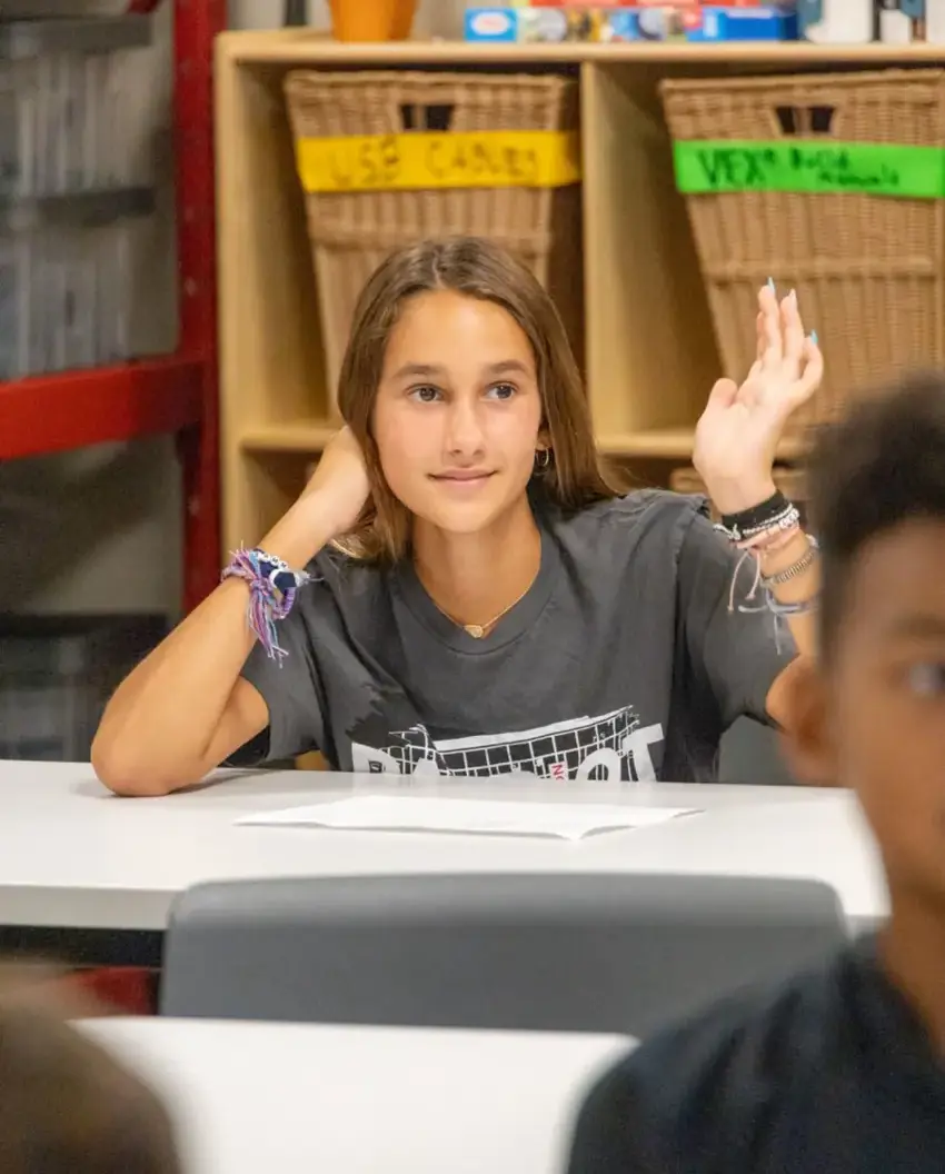 Middle School student raising their hand