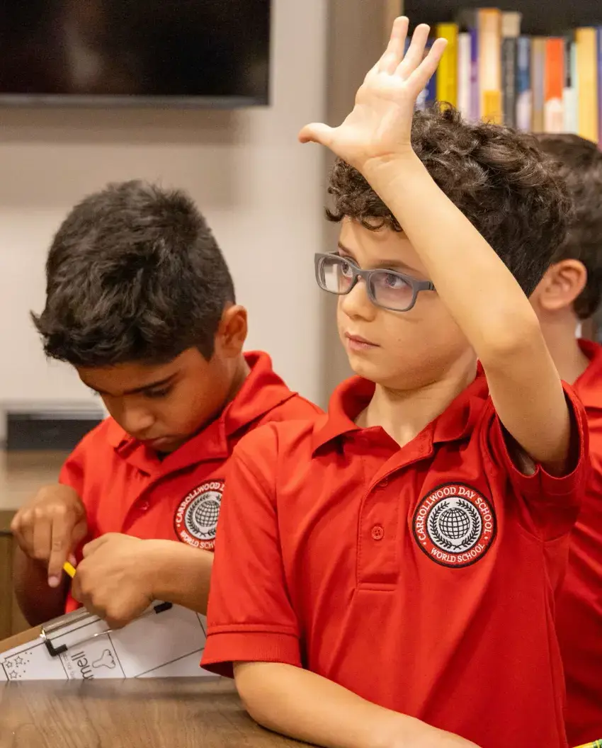 Elementary student raising their hand